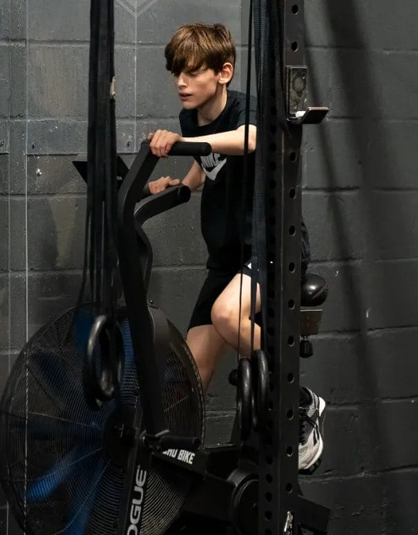 Teen on ROGUE Bike at CrossFit Tunbridge Wells